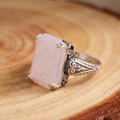 White Opal Antique Silver Ring on a tree-trunk slab
