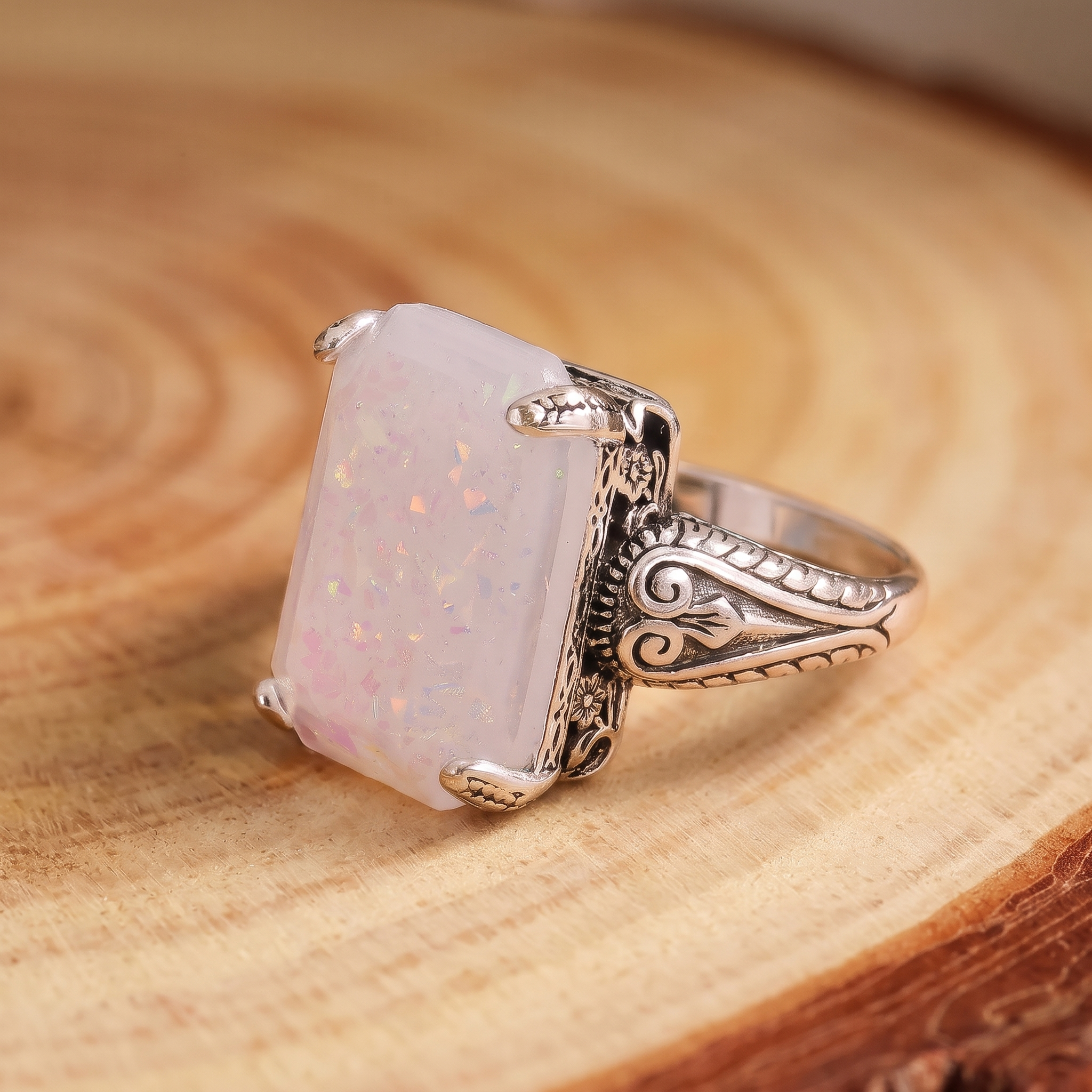 White Opal Antique Silver Ring on a tree-trunk slab