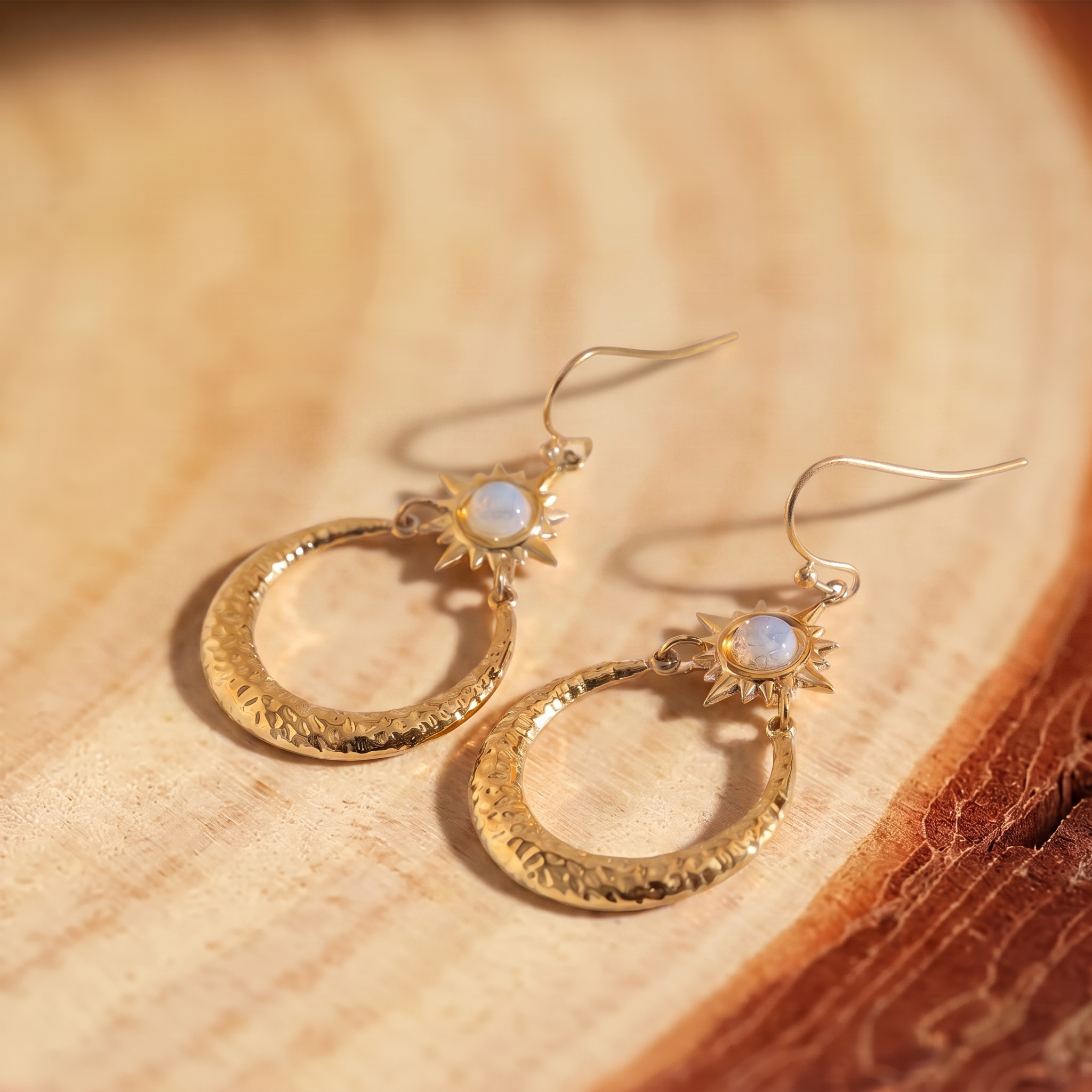 Opal Sunburst Hammered Hoop Earrings on a tree-trunk slab