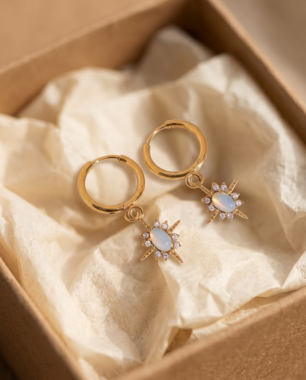 Celestial Opal Star Huggie Hoops in a kraft gift box