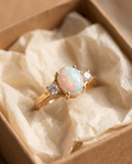 White Opal Three-Stone Gold Ring in a kraft gift box