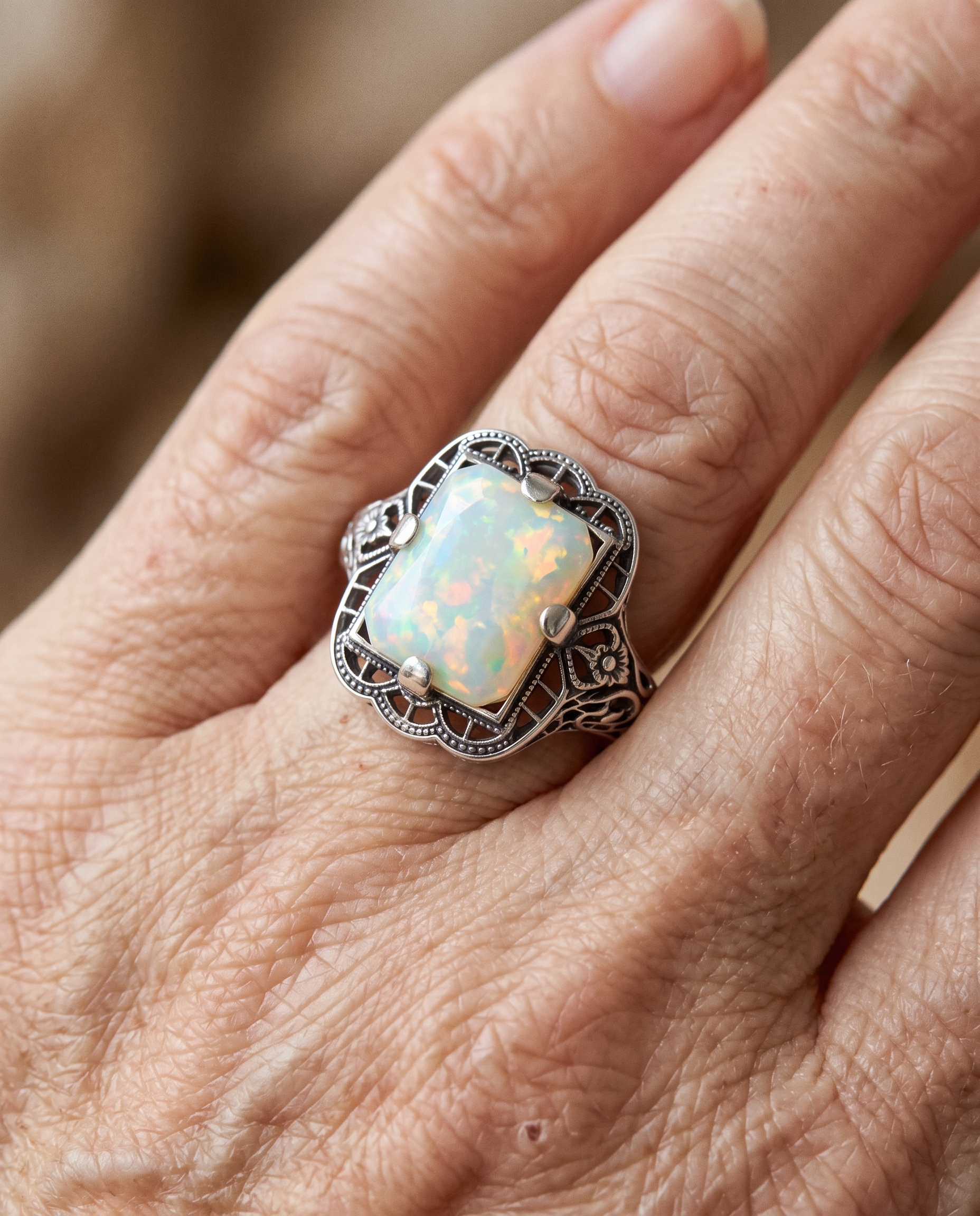 White Opal Filigree Silver Ring worn on a model