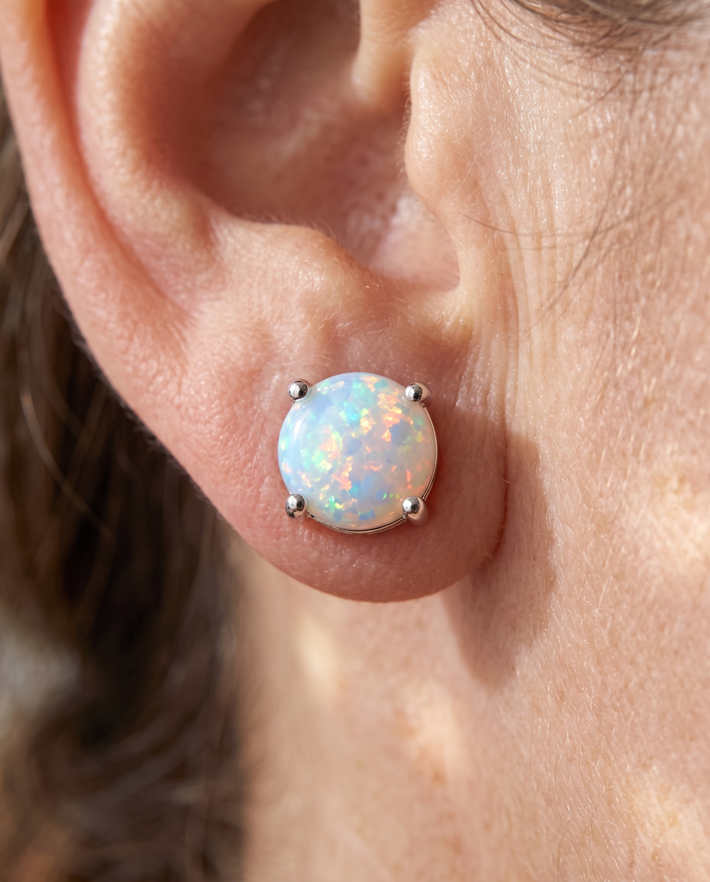 White Opal Silver Stud Earrings worn on a model