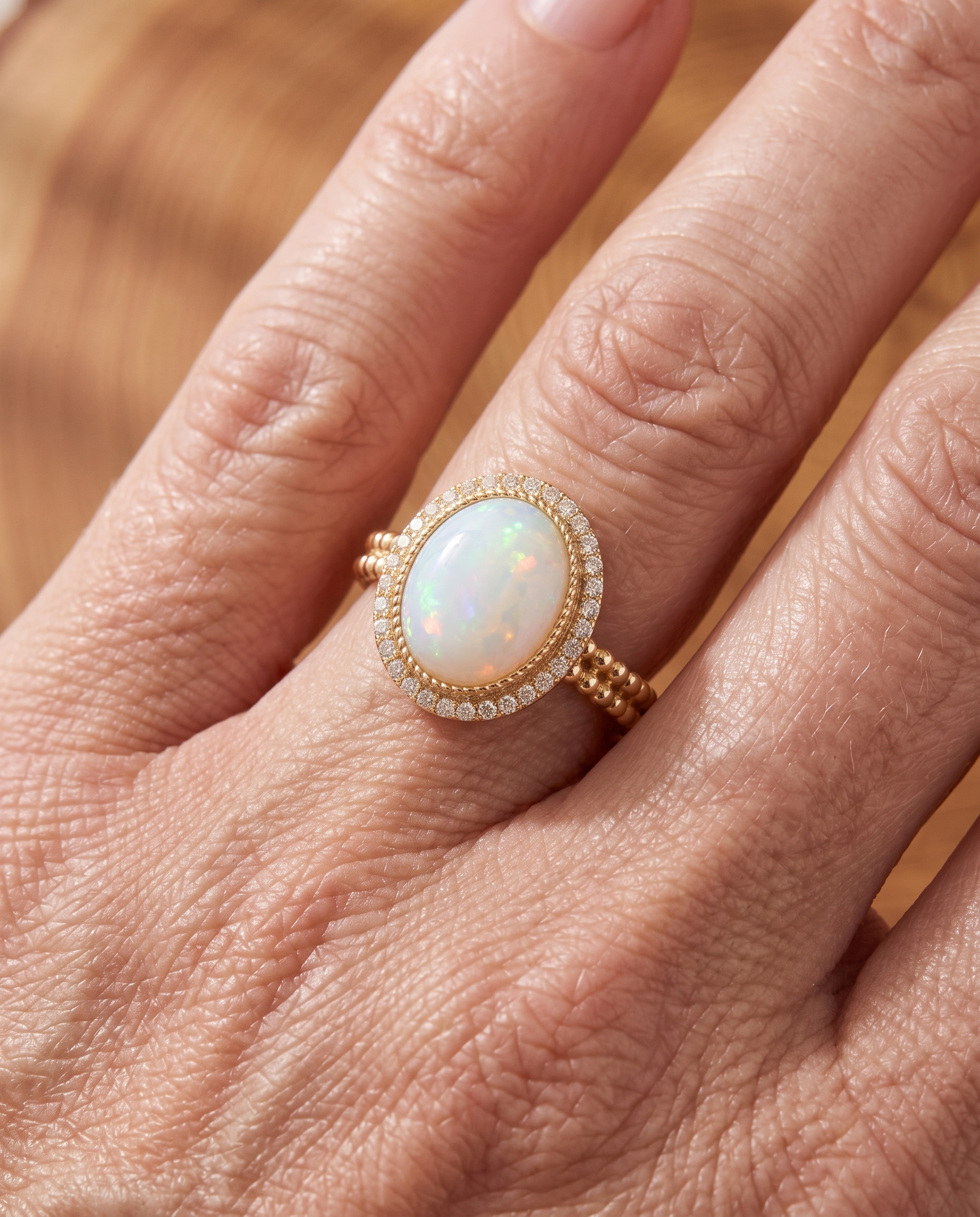 White Opal Halo Gold Ring worn on a model