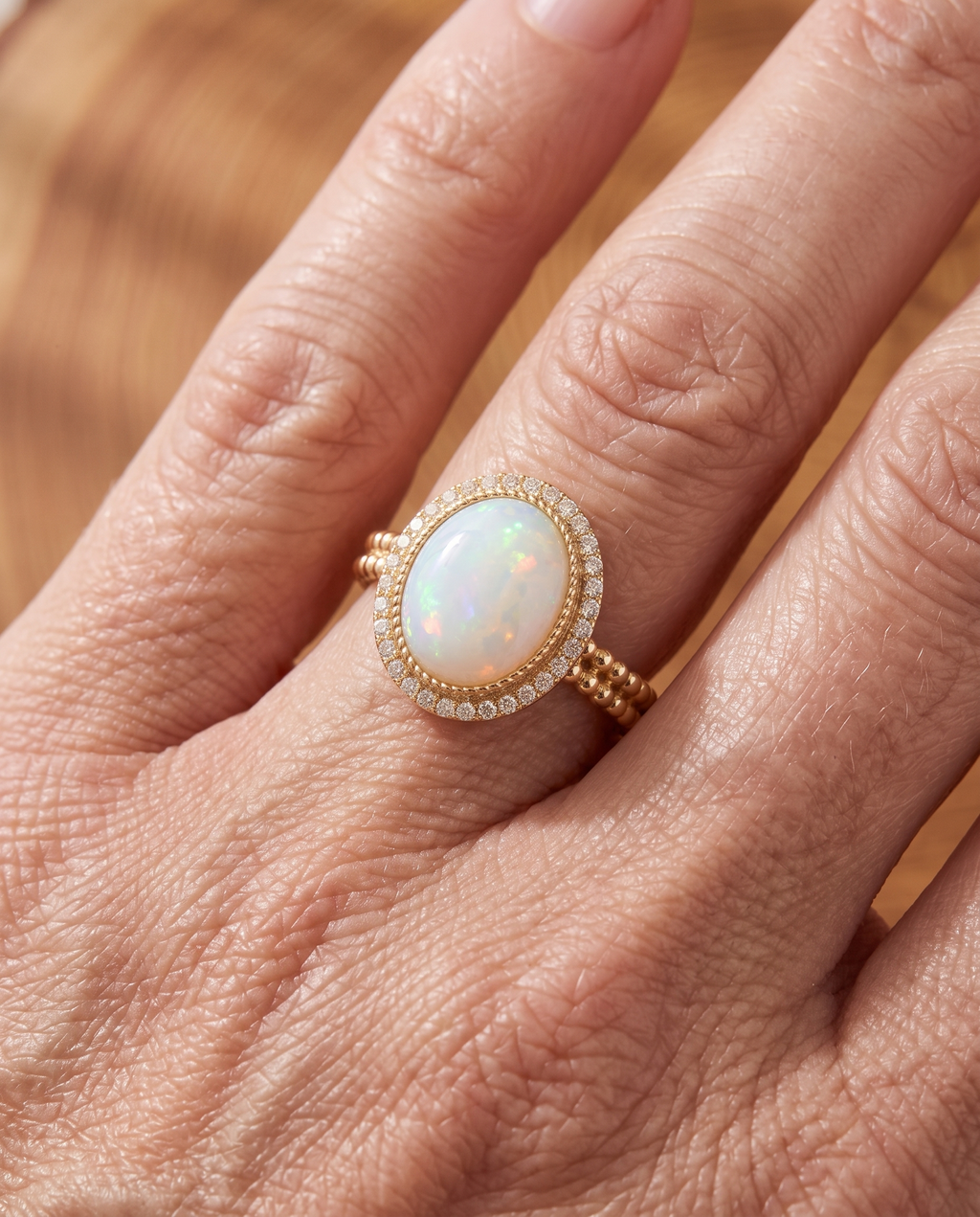 White Opal Halo Gold Ring worn on a model