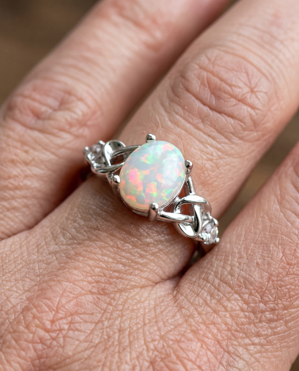 White Opal Celtic Knot Silver Ring worn on a model