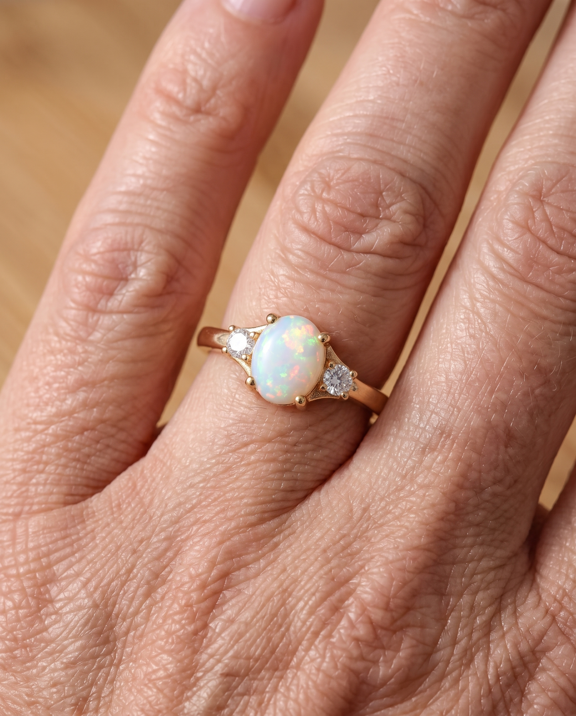 White Opal Three-Stone Gold Ring worn on a model