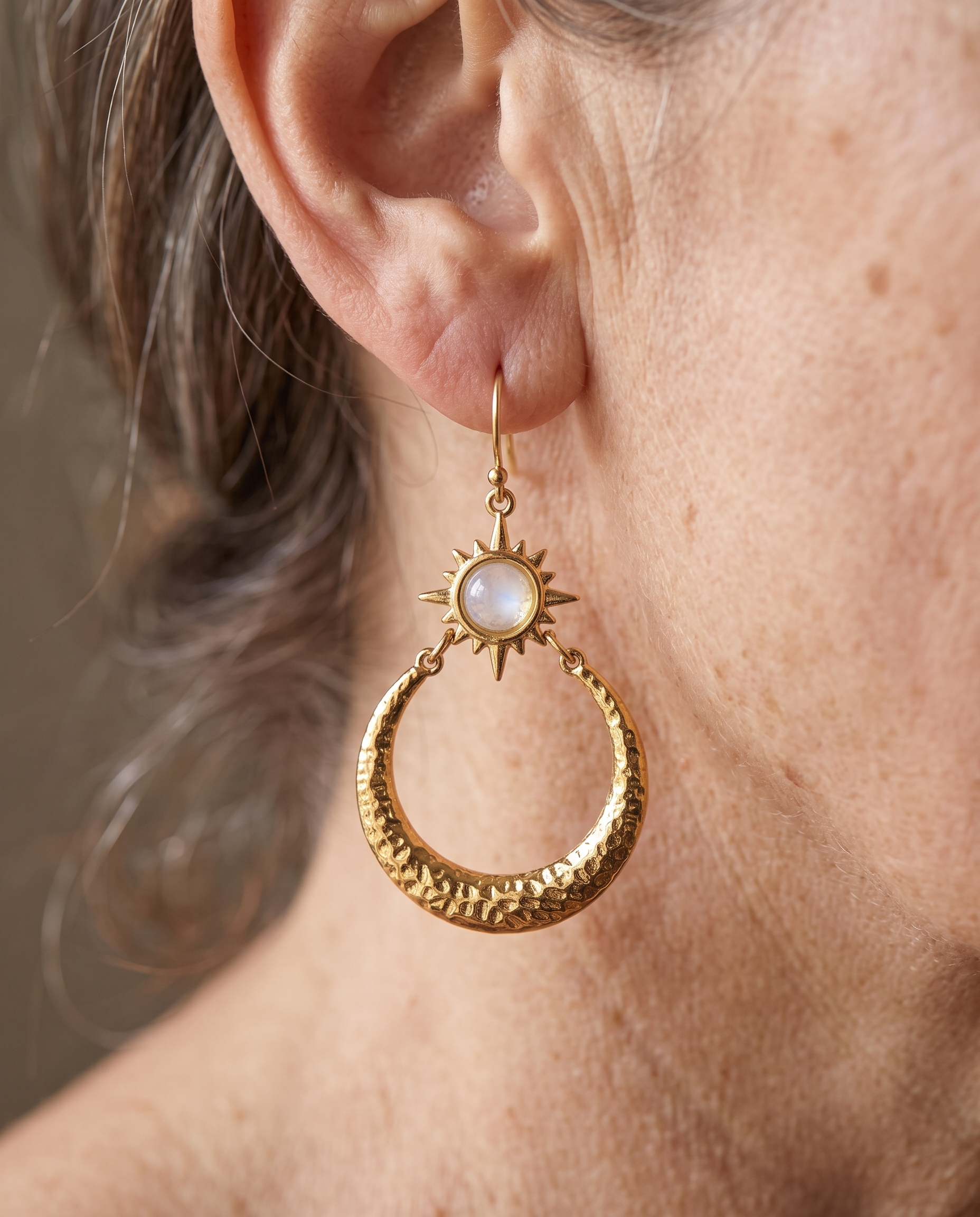 Opal Sunburst Hammered Hoop Earrings worn on a model