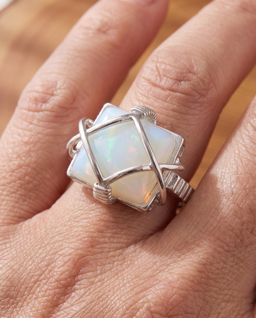 White Opal Wire-Wrapped Silver Ring worn on a model