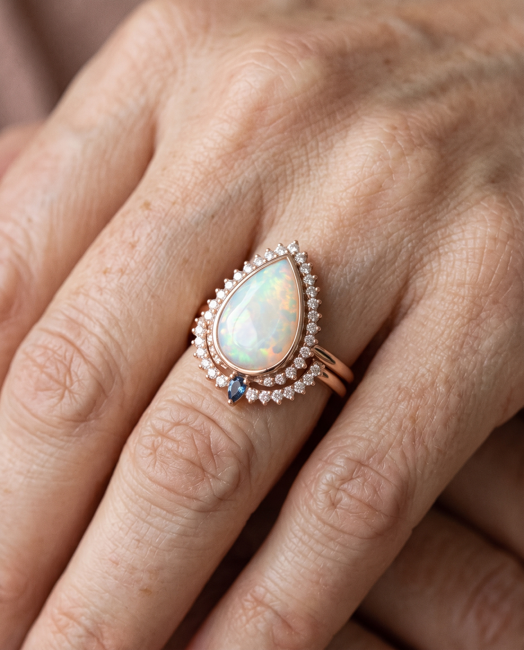 White Opal Teardrop Rose Gold Ring worn on a model