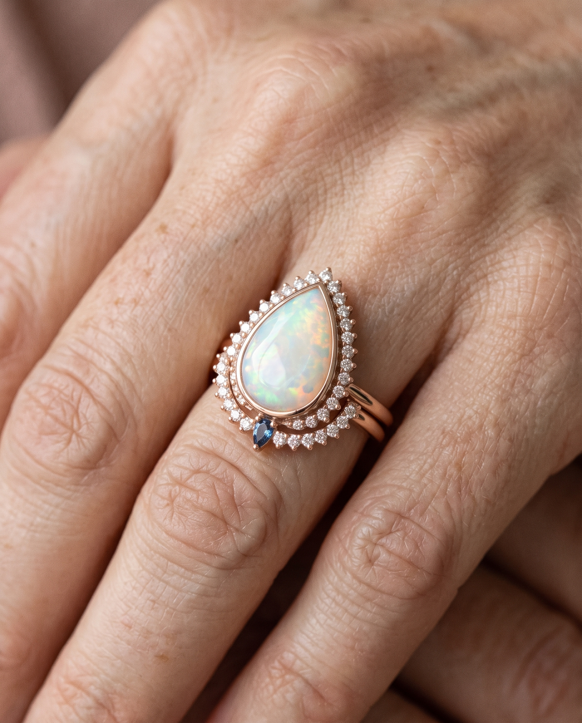 White Opal Teardrop Rose Gold Ring worn on a model