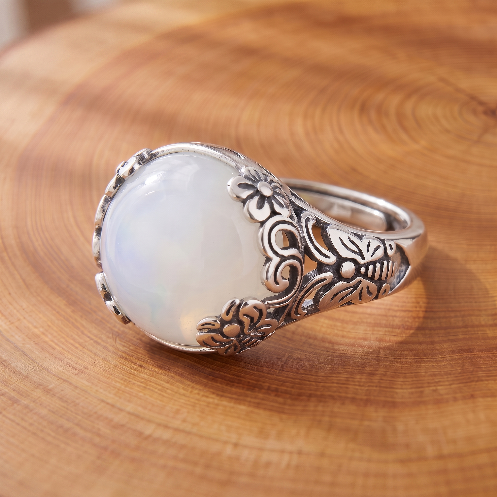 Grand White Opal Garden Ring on a tree-trunk slab